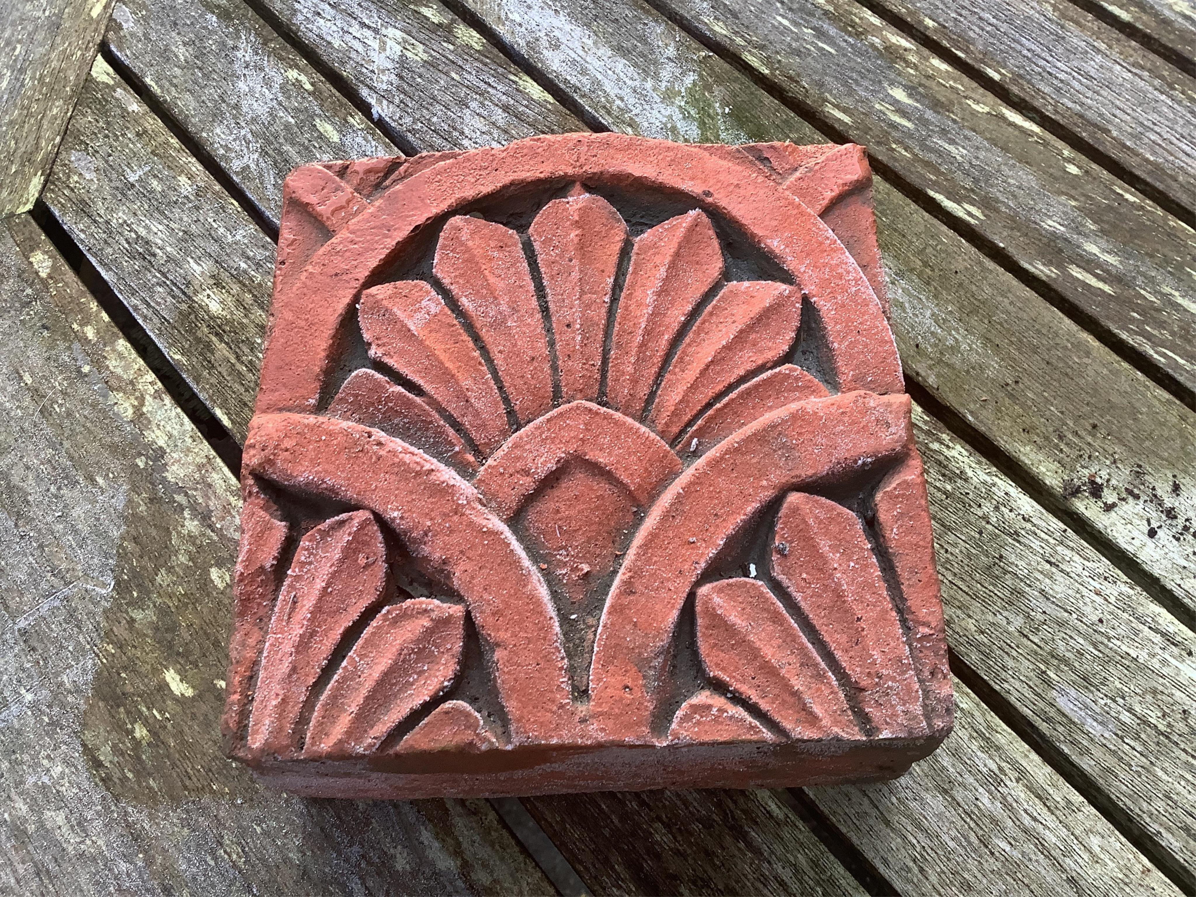 Six terracotta decorative tiles, largest width 21cm. Condition - fair